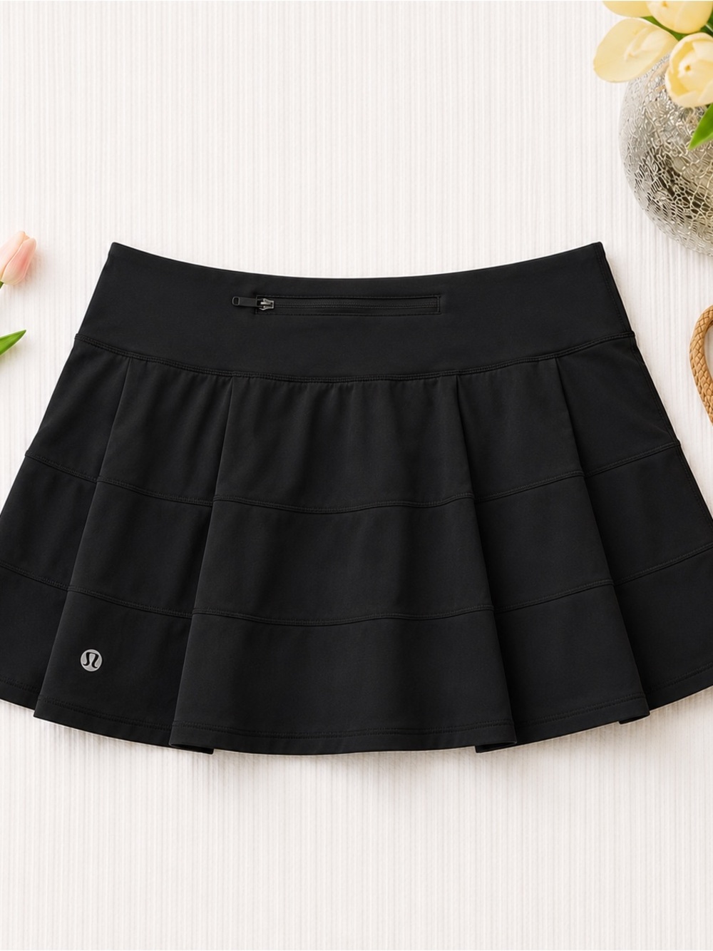 Black Lululemon Pace Rival Mid-Rise athletic skirt.